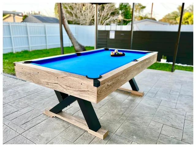 a view of an outdoor space with pool and furniture
