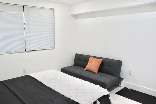 a bedroom with a bed and a night stand