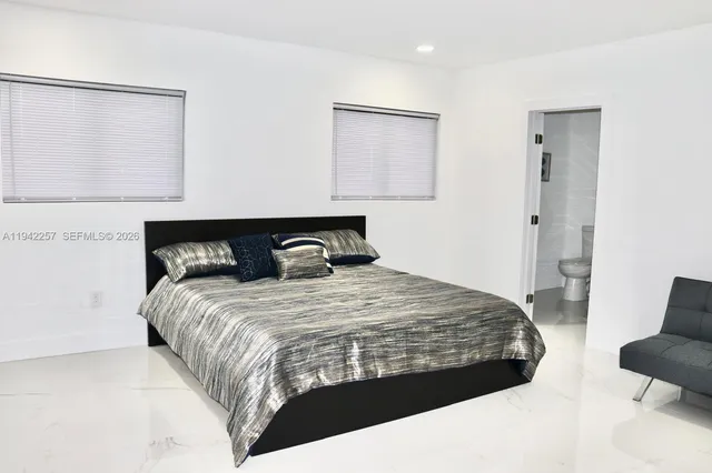 a bedroom with a bed and chair