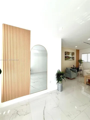 a view of a livingroom with furniture and mirror