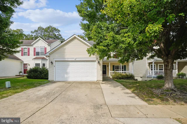 a front view of house with yard and trees