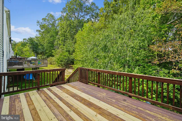 a view of balcony with wooden floor and fence