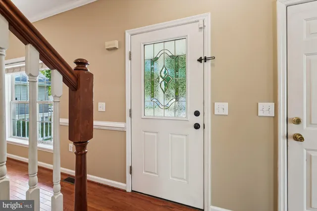 a view of entryway with wooden floor and windows