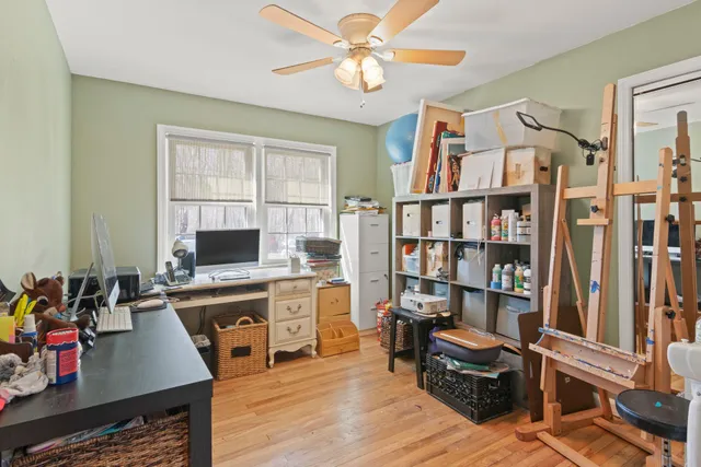 a view of a workspace with furniture and a window
