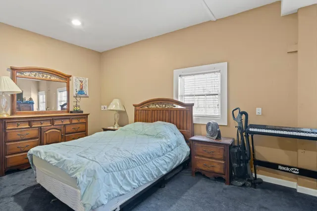 a bedroom with a bed and a dresser