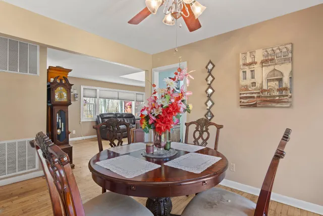 a dining room with furniture and wooden floor