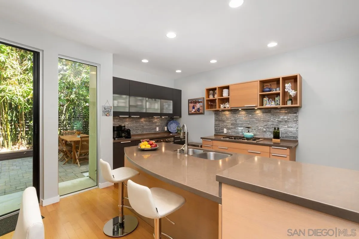 714 Bonair Way La Jolla, CA 92037 - Photo 14 of 36 a kitchen with stainless steel appliances granite countertop a refrigerator a sink a stove a dining table and chairs