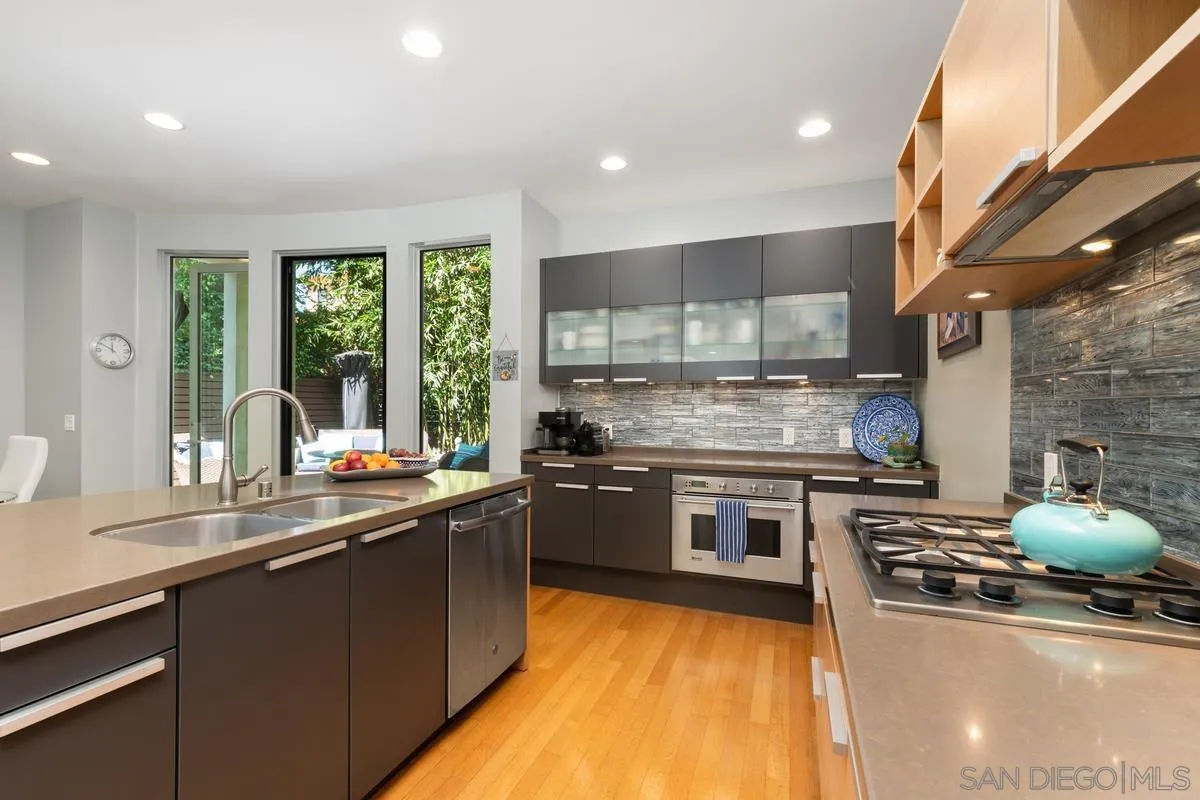 714 Bonair Way La Jolla, CA 92037 - Photo 16 of 36 a kitchen with stainless steel appliances granite countertop a stove a sink and a microwave