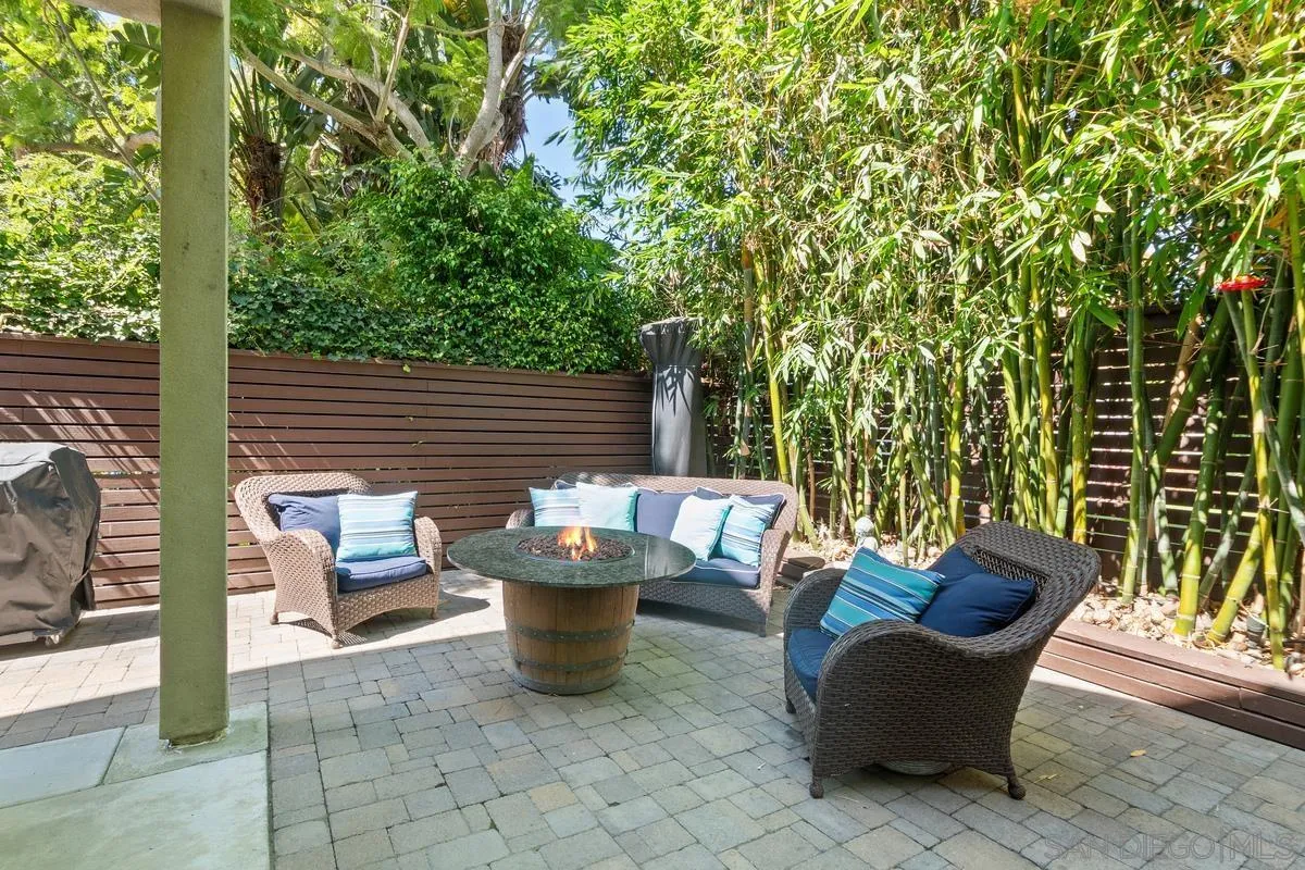 714 Bonair Way La Jolla, CA 92037 - Photo 24 of 36 a view of a patio with table and chairs and wooden fence