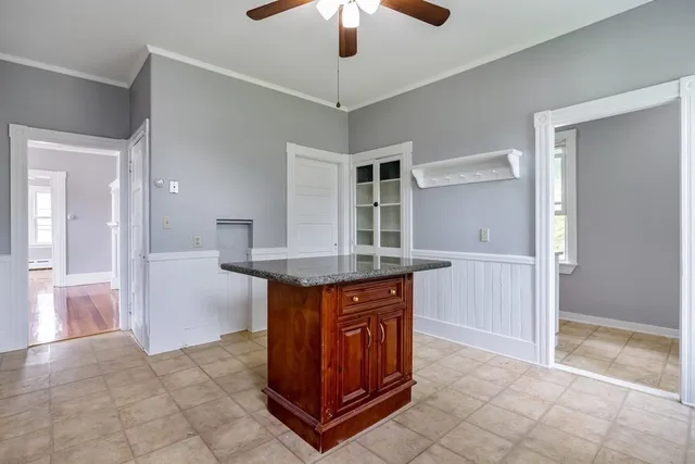 a kitchen with granite countertop a table and chairs in it