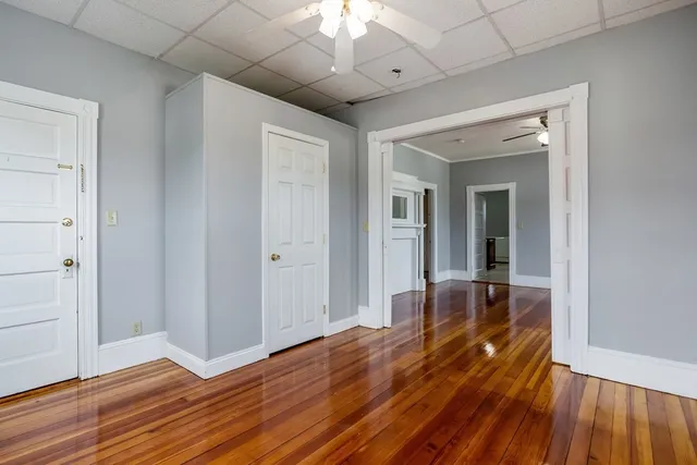 wooden floor in an empty room with a window