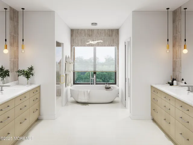 a bathroom with a double vanity sink a large mirror a bathtub and window