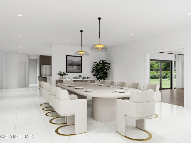 a dining room with furniture a large window and a chandelier