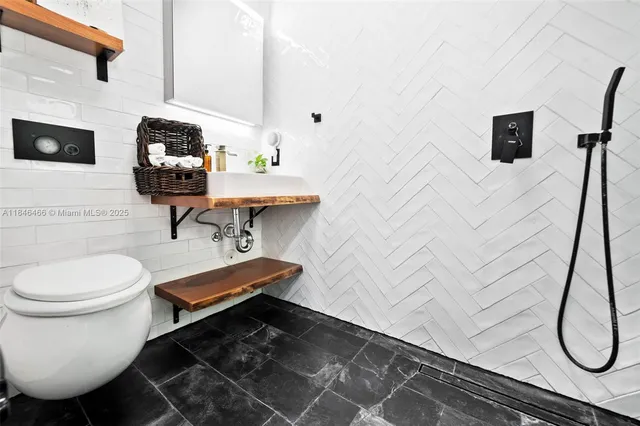 a bathroom with a toilet sink and mirror
