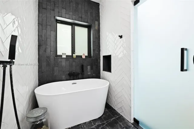 a white bath tub sitting next to a white toilet