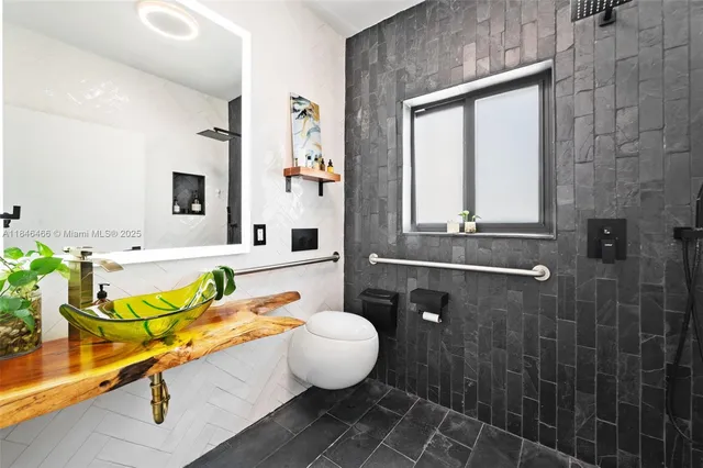 a bathroom with a sink mirror and tub