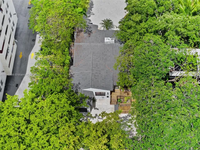 an aerial view of a house with a yard and lake view