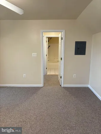a view of an empty room and a bathroom
