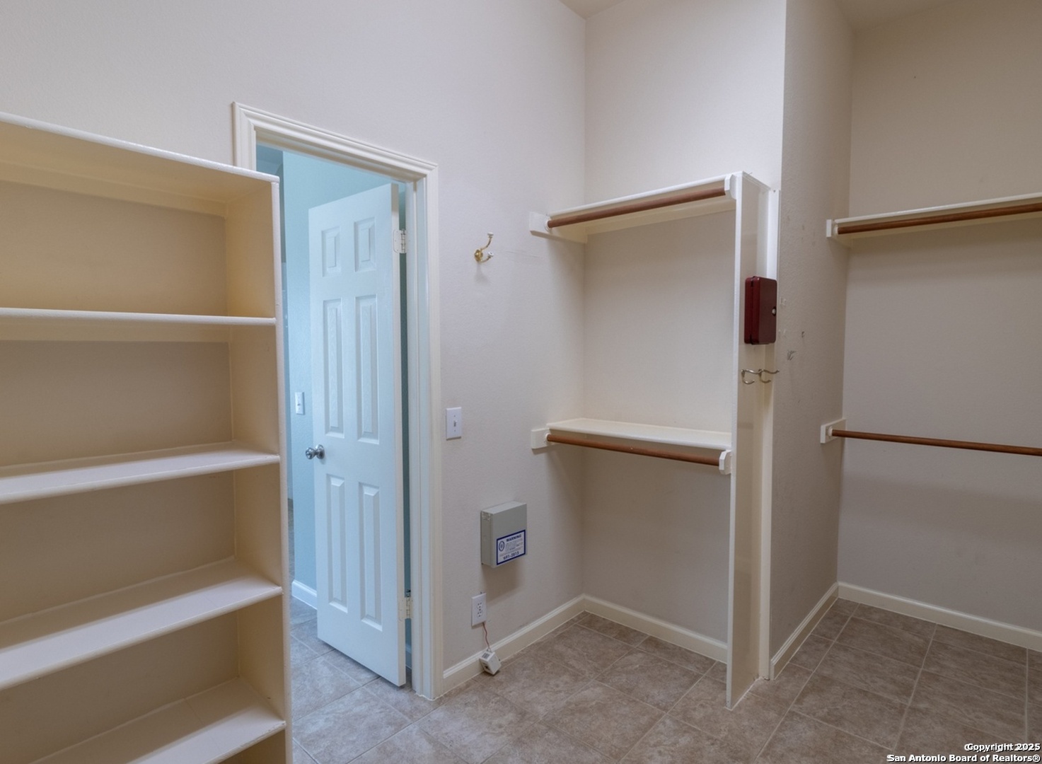 716 Broadleaf Schertz, TX 78154 - Photo 19 of 25 a view of walk in closet with empty racks