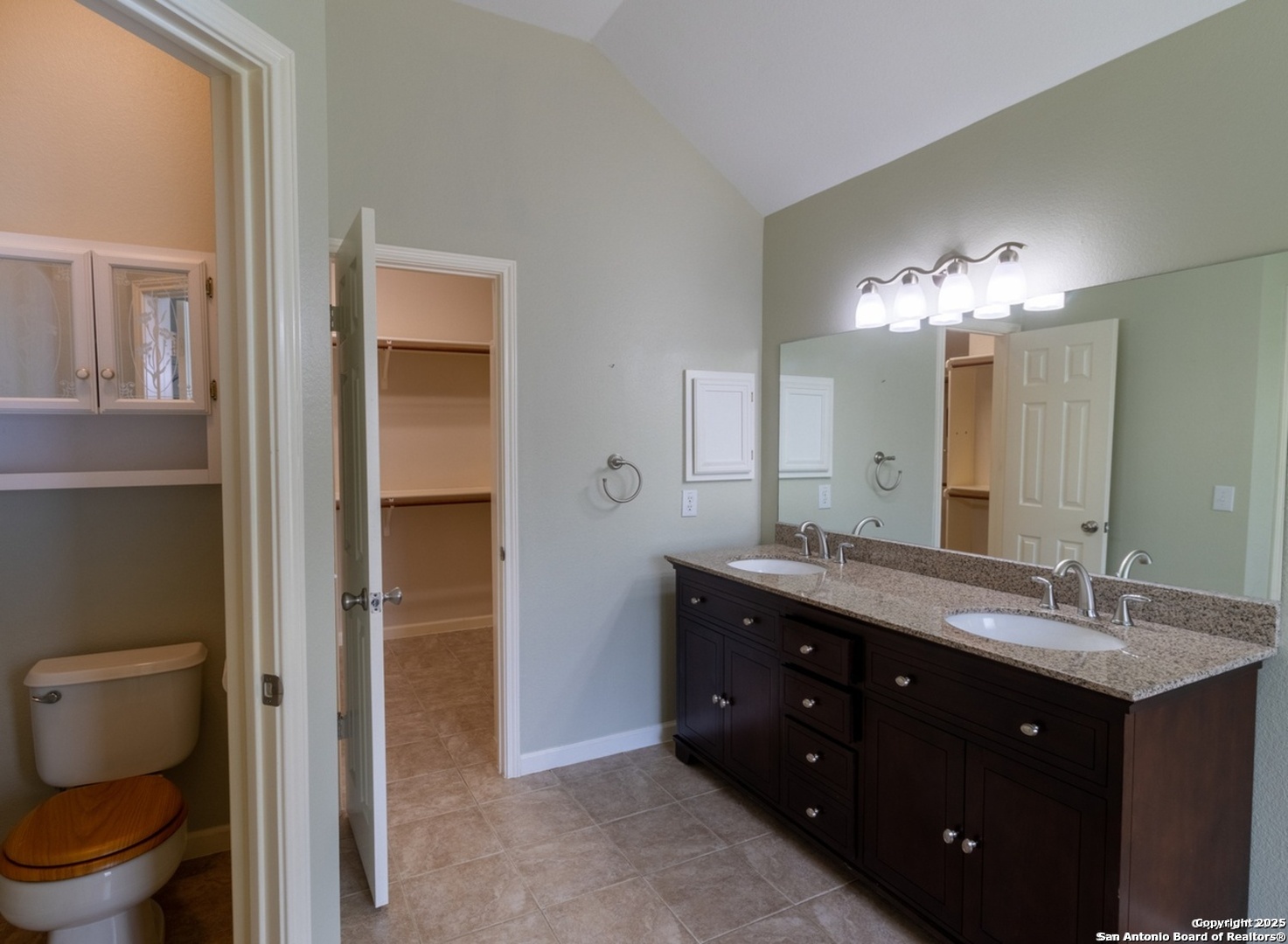 716 Broadleaf Schertz, TX 78154 - Photo 20 of 25 a spacious bathroom with a granite countertop sink a toilet and a mirror