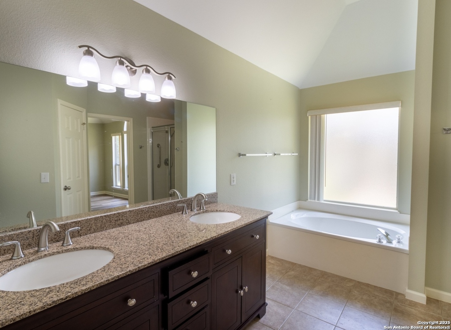 716 Broadleaf Schertz, TX 78154 - Photo 21 of 25 a bathroom with a granite countertop sink and a large mirror