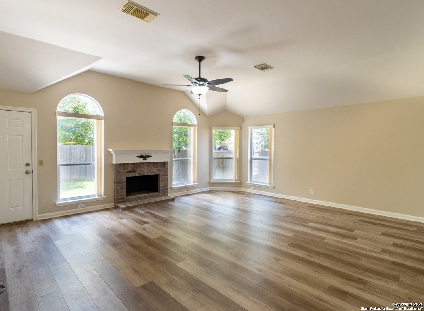 716 Broadleaf Schertz, TX 78154 - Photo 4 of 25 wooden floor fireplace and windows in an empty room