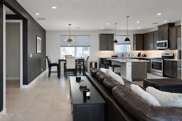 a large kitchen with a table and chairs