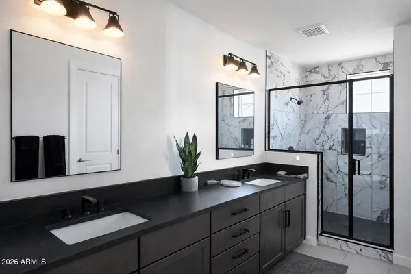 a bathroom with a double vanity sink and mirror