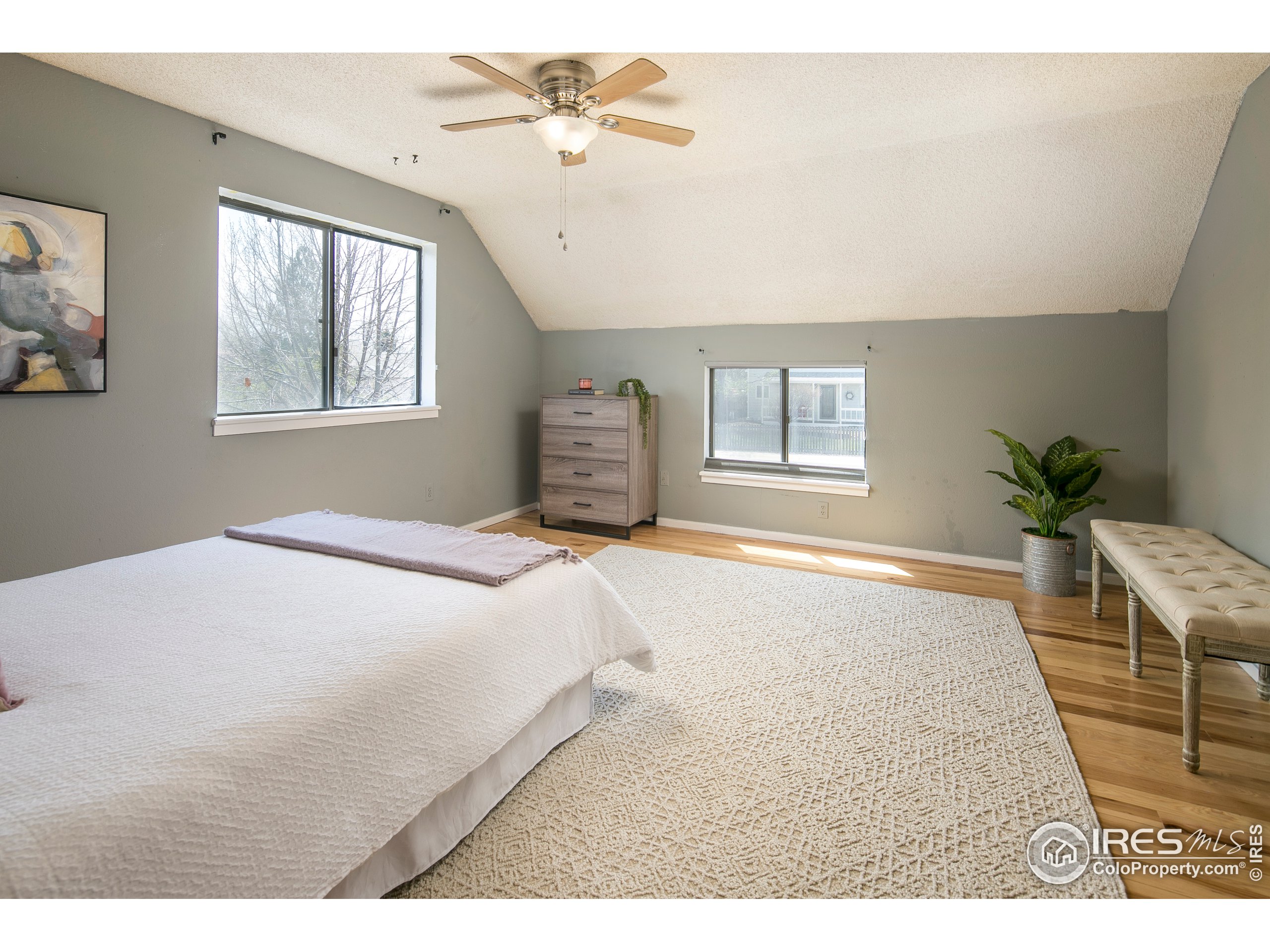 595 West Street Louisville, CO 80027 - Photo 14 of 26 a bedroom with a large bed and a window