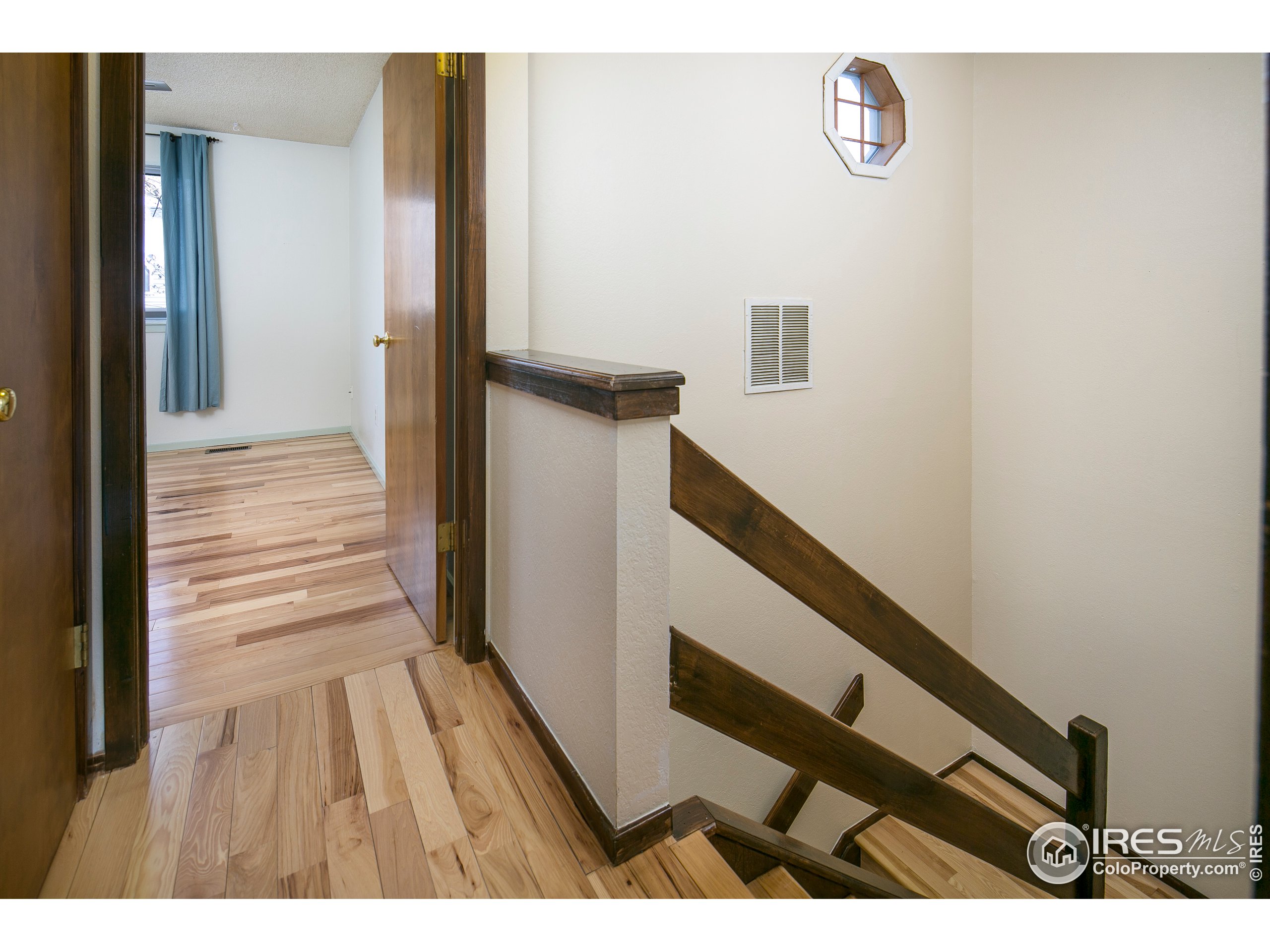 595 West Street Louisville, CO 80027 - Photo 18 of 26 a view of a hallway with wooden floor and staircase