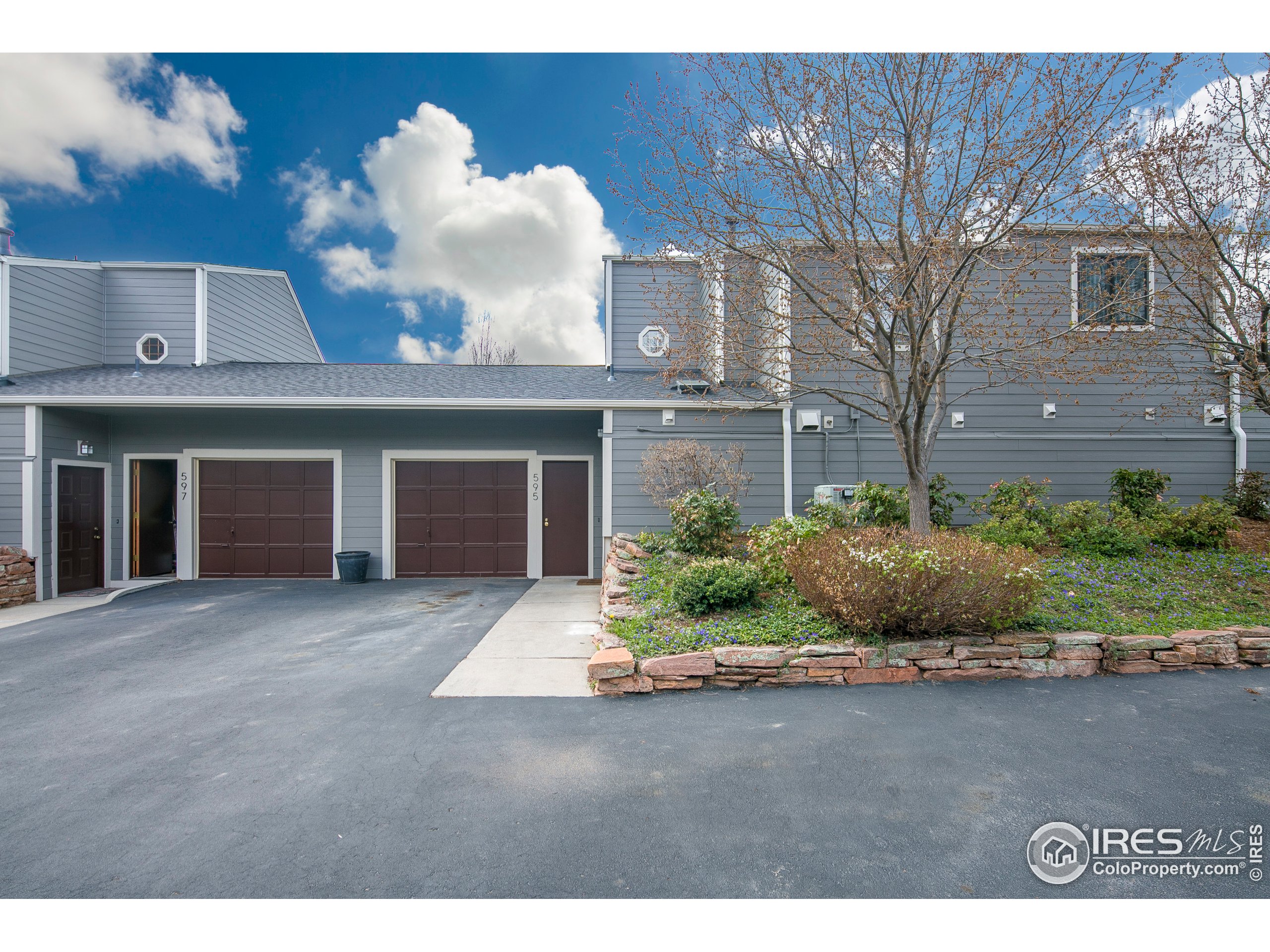 595 West Street Louisville, CO 80027 - Photo 4 of 26 a front view of a house with a yard and garage