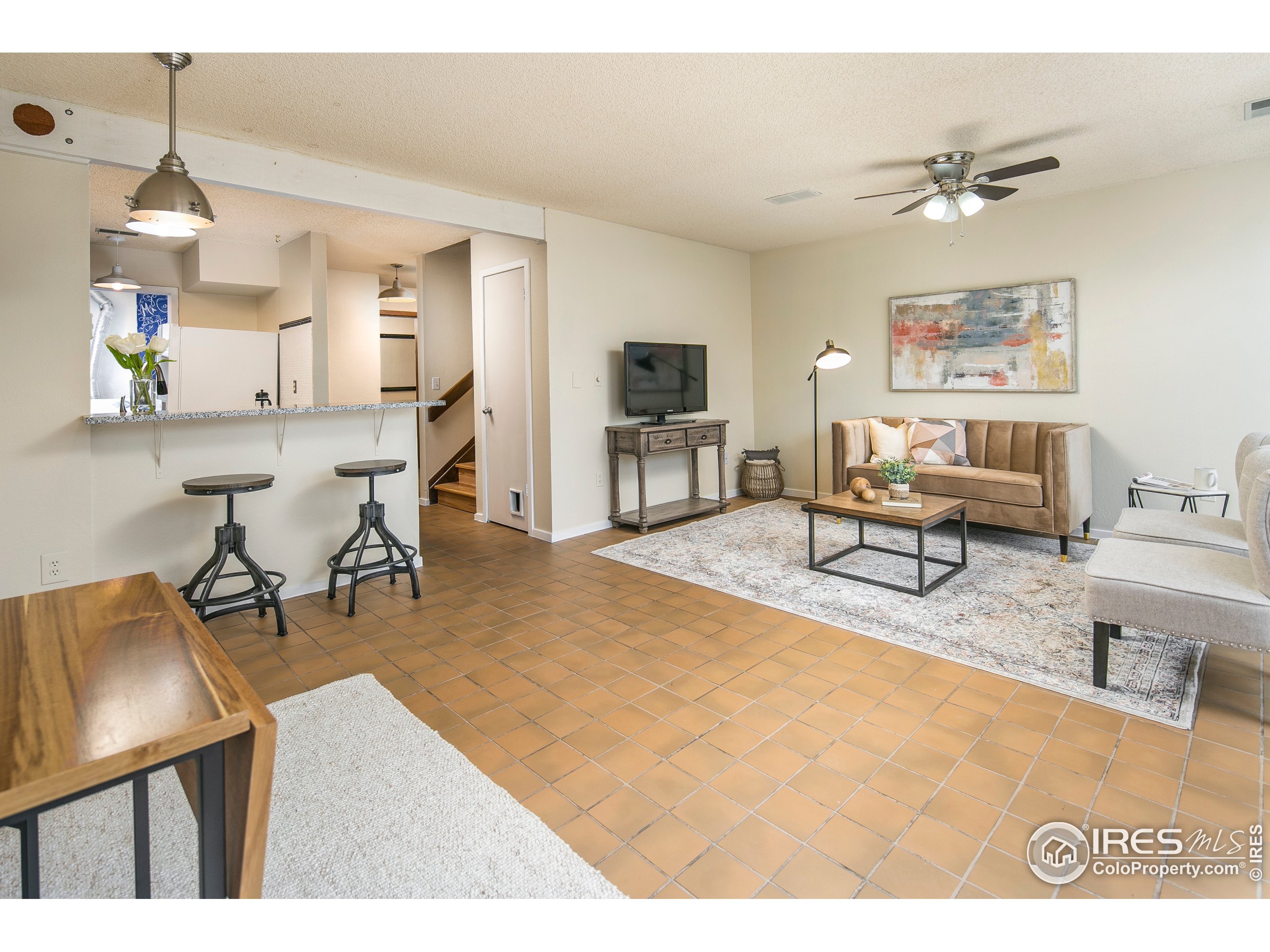 595 West Street Louisville, CO 80027 - Photo 7 of 26 a living room with furniture and a flat screen tv