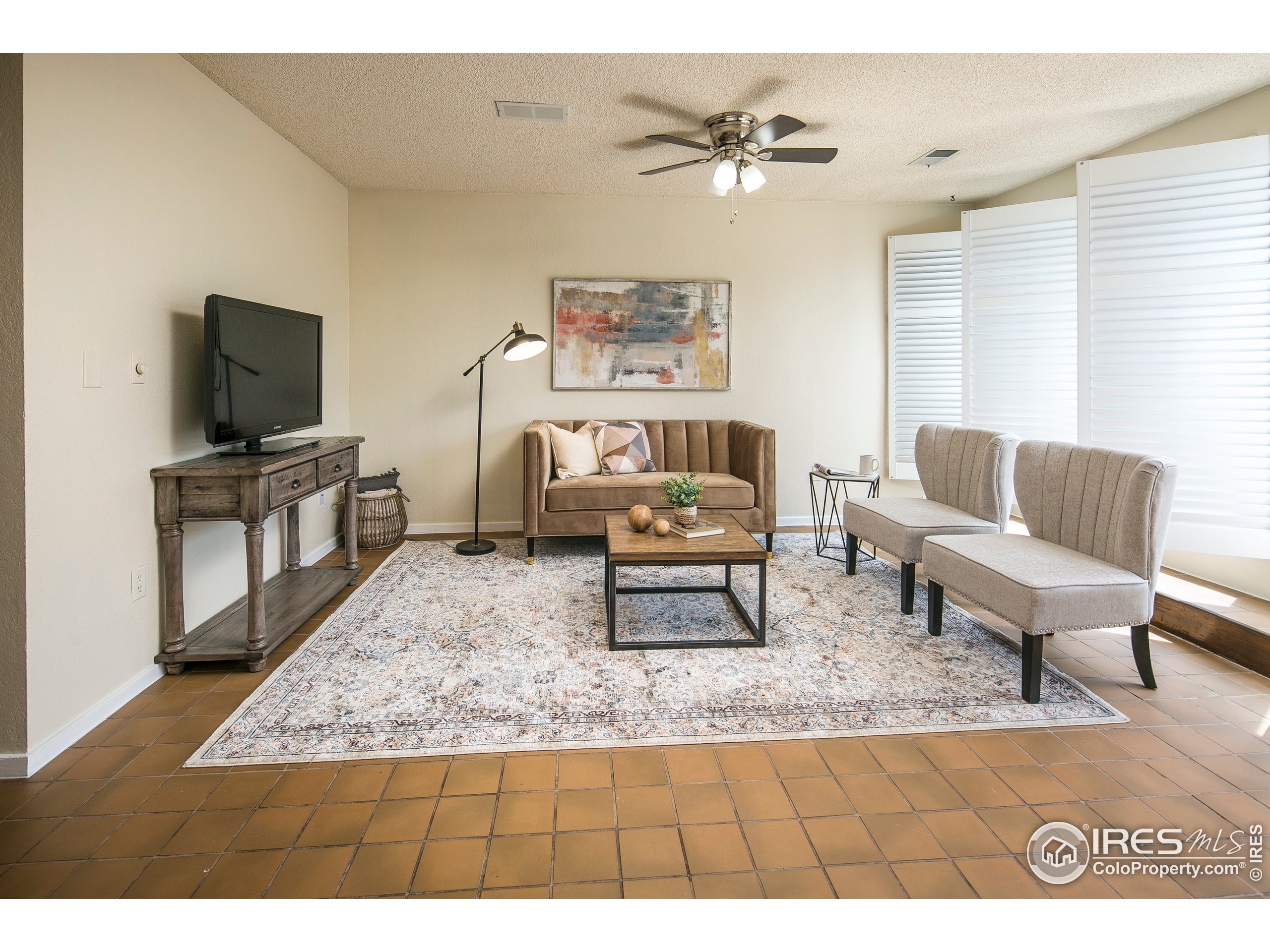 595 West Street Louisville, CO 80027 - Photo 9 of 26 a living room with furniture and a flat screen tv