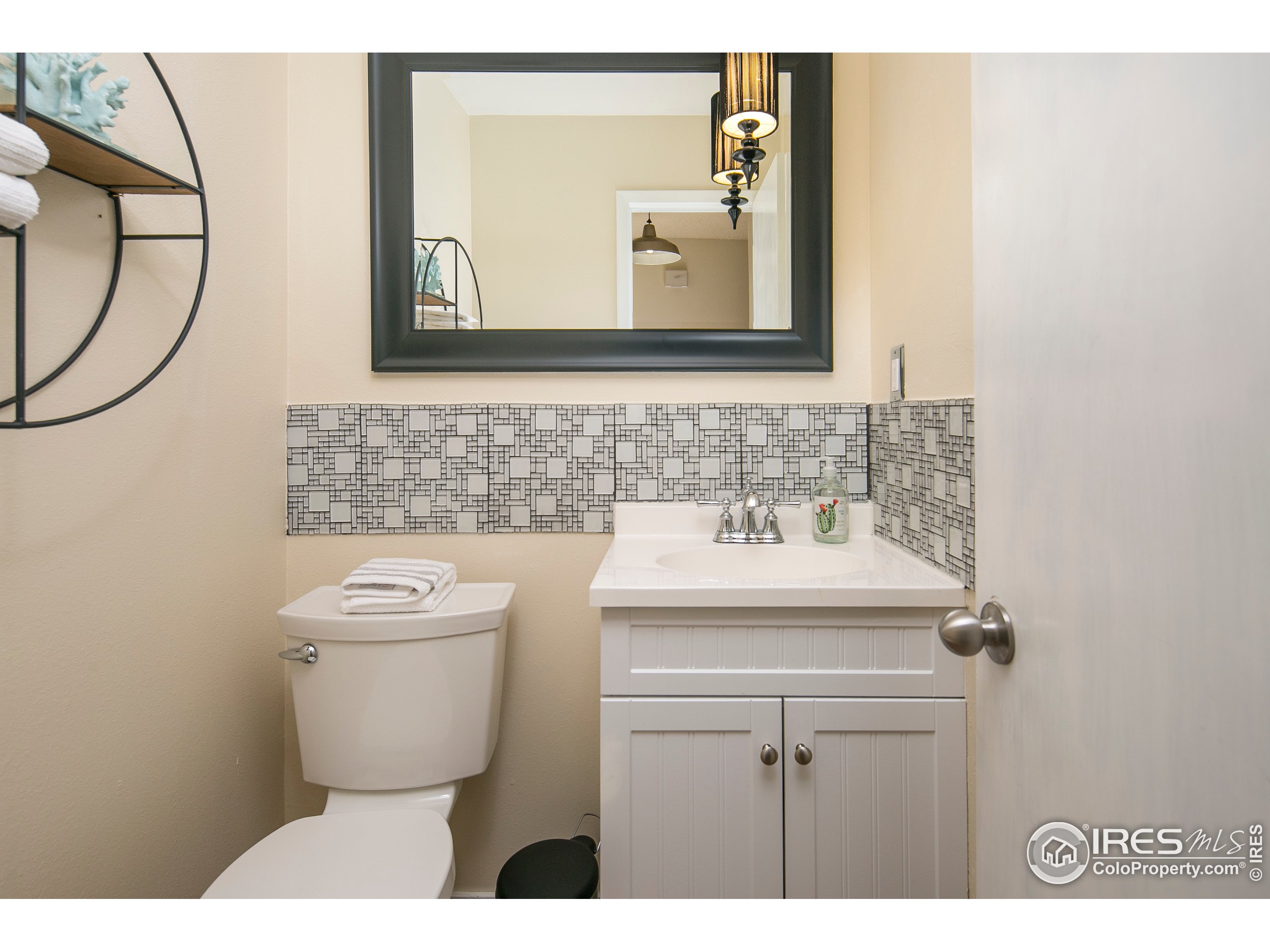 595 West Street Louisville, CO 80027 - Photo 10 of 26 a bathroom with a toilet sink and mirror