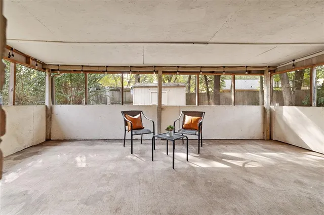 a living room with furniture and a floor to ceiling window