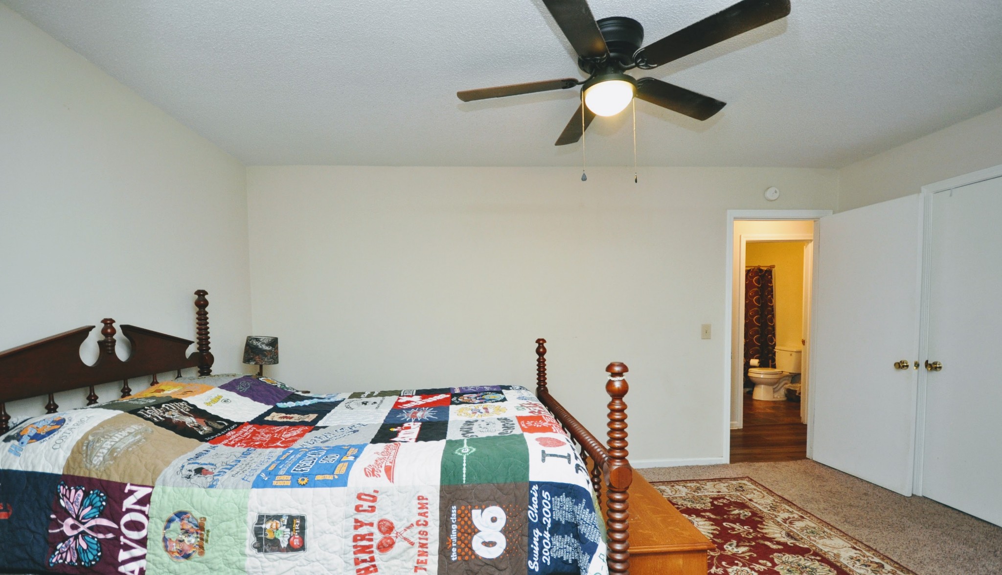 290 Lakeview Manor Road Springville, TN 38256 - Photo 9 of 36 a bedroom with a bed and a chandelier