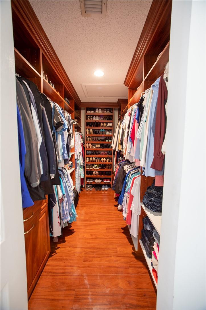 108 West Lee Road Delray Beach, FL 33445 - Photo 17 of 32 a view of walk in closet with clothes and shoes