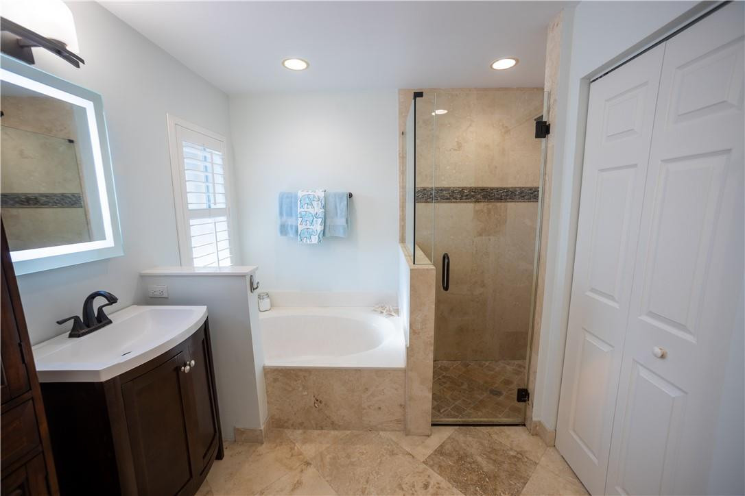 108 West Lee Road Delray Beach, FL 33445 - Photo 19 of 32 a bathroom with a bathtub a shower a sink and a window