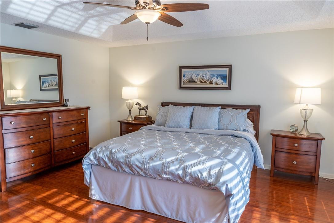 108 West Lee Road Delray Beach, FL 33445 - Photo 21 of 32 a bedroom with a bed and a lamp on dresser