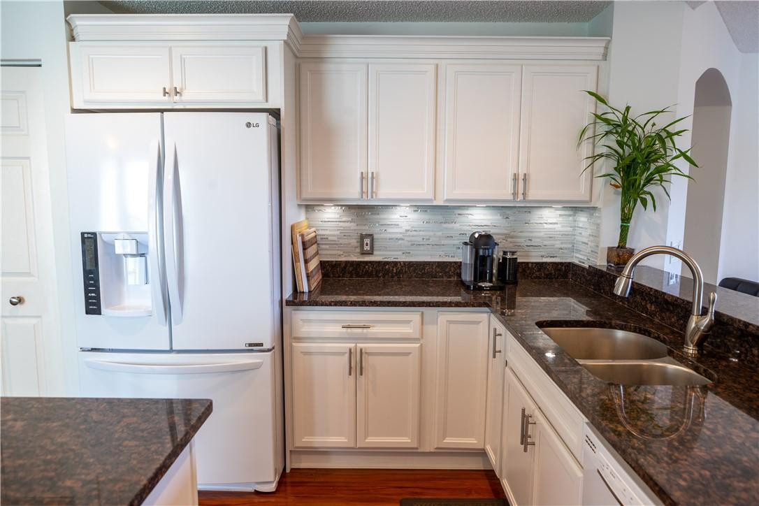 108 West Lee Road Delray Beach, FL 33445 - Photo 5 of 32 a kitchen with appliances a sink and cabinets