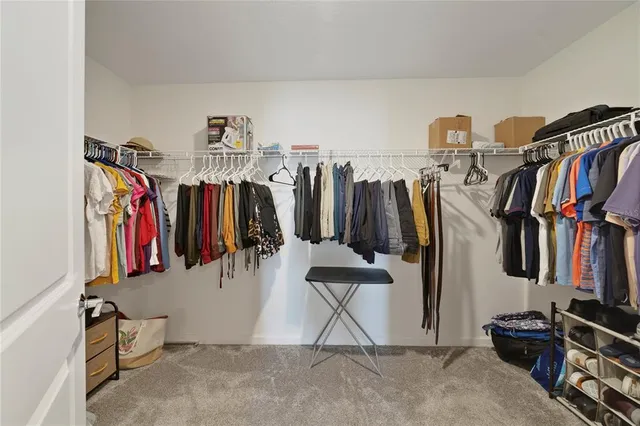 a bedroom with a bed and a dresser next to a window