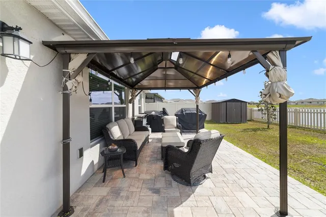 a view of a patio with a table and chairs