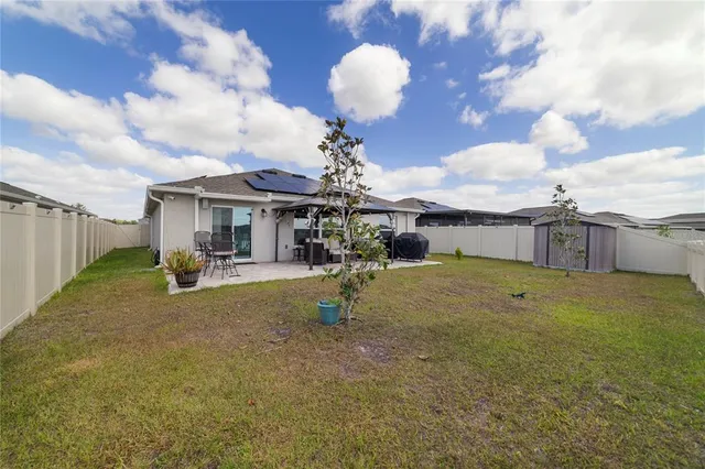 a view of a house with backyard porch and sitting area