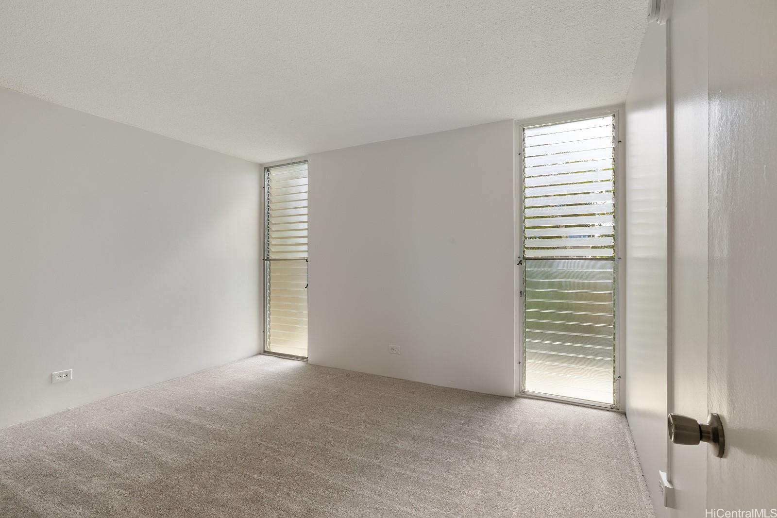3103 Pualei Circle, Unit 203 Honolulu, HI 96815 - Photo 11 of 25 The master bedroom has floor to ceiling windows.