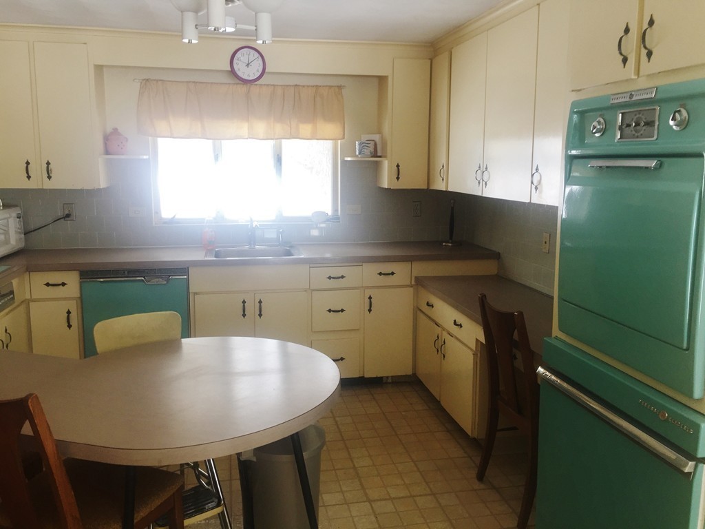 12 Nadine Road Framingham, MA 01701 - Photo 10 of 21 a kitchen with a table chairs sink and cabinets