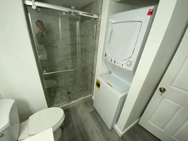 a bathroom with a toilet and a shower