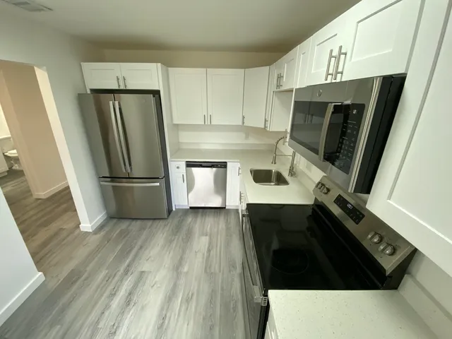a kitchen with a refrigerator and a sink