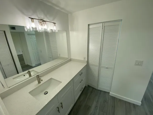a bathroom with shower sink and mirror