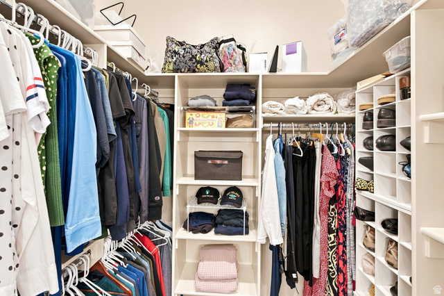 5207 North Oldgate Road Heber City, UT 84032 - Photo 21 of 58 Built-in closet system featuring multiple hanging rods, adjustable shelving, and dedicated shoe cubbies
