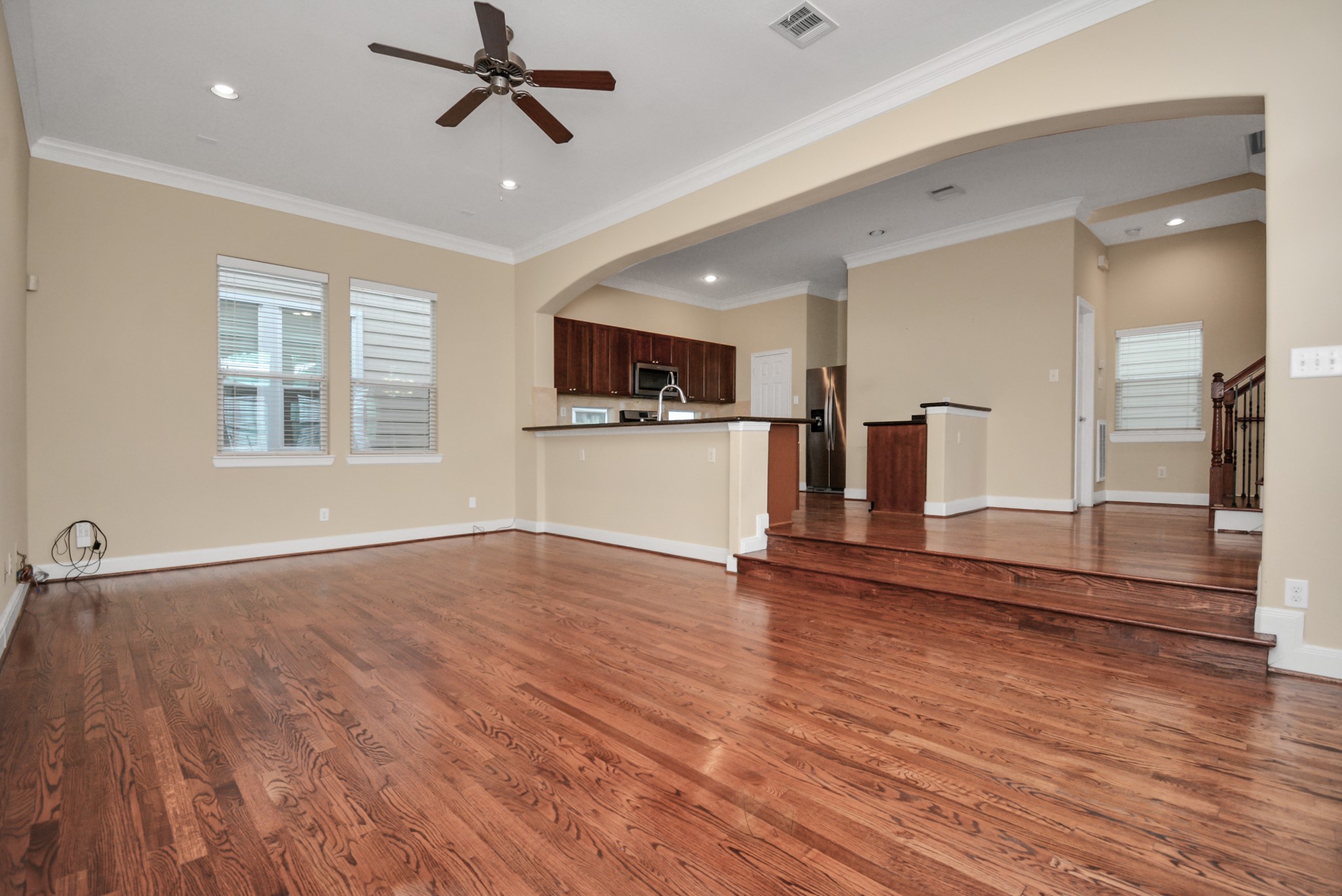 1137 West 24th Street, Unit A Houston, TX 77008 - Photo 13 of 40 a view of a kitchen with wooden floor and a ceiling fan